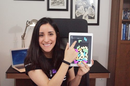 A woman showing off a game on a tablet — Estefannie Explains it All 美女写真集 Pi