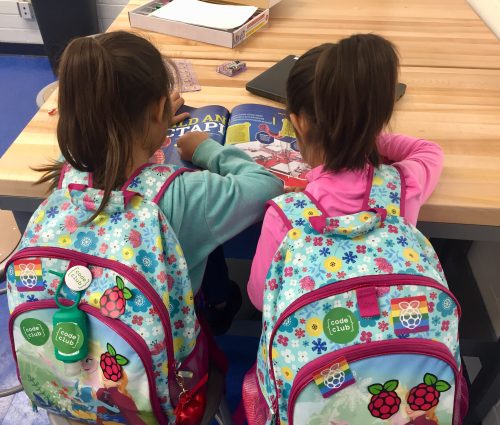 Two girls with backpacks reading about a 国产欧美久久一区二区 Pi project — Boys & Girls Club