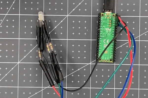 X0X0性视频 Pi Pico attached with jumper wires to a purple LED.