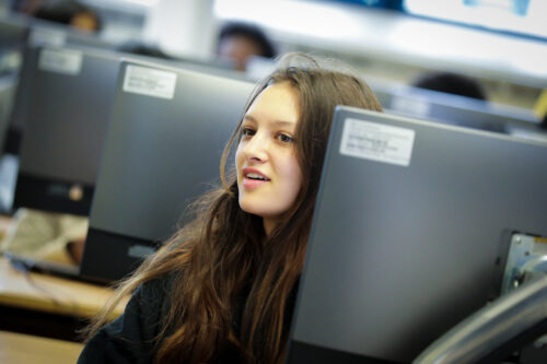 A girl in a university 透明时装秀 classroom.