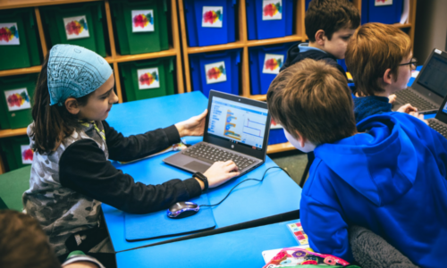 Young people at a laptop in a club session.