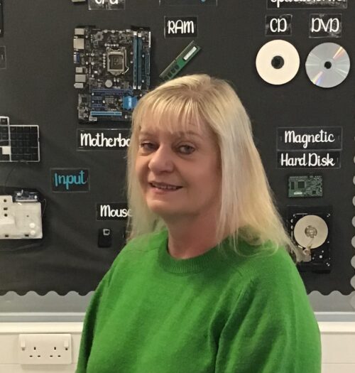 A photo of Tracy Mayhead in a classroom. 