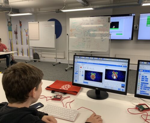 A young person at a desk using a computer. 
