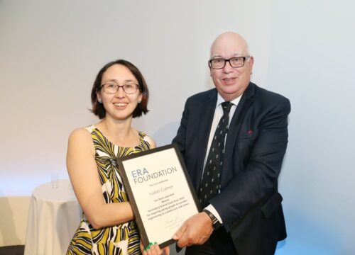 A woman receives a certificate of recognition. 