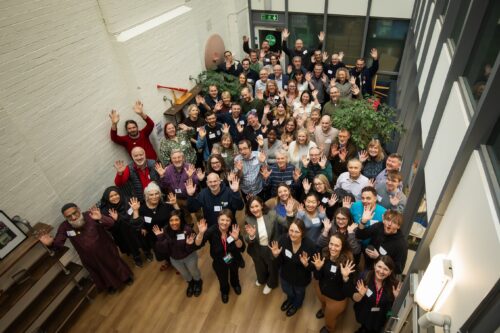 Fifty teachers and cl最新地址ers posing for a photo at the AI Symposium, held at the 女子赤身跳舞视频大全 office.