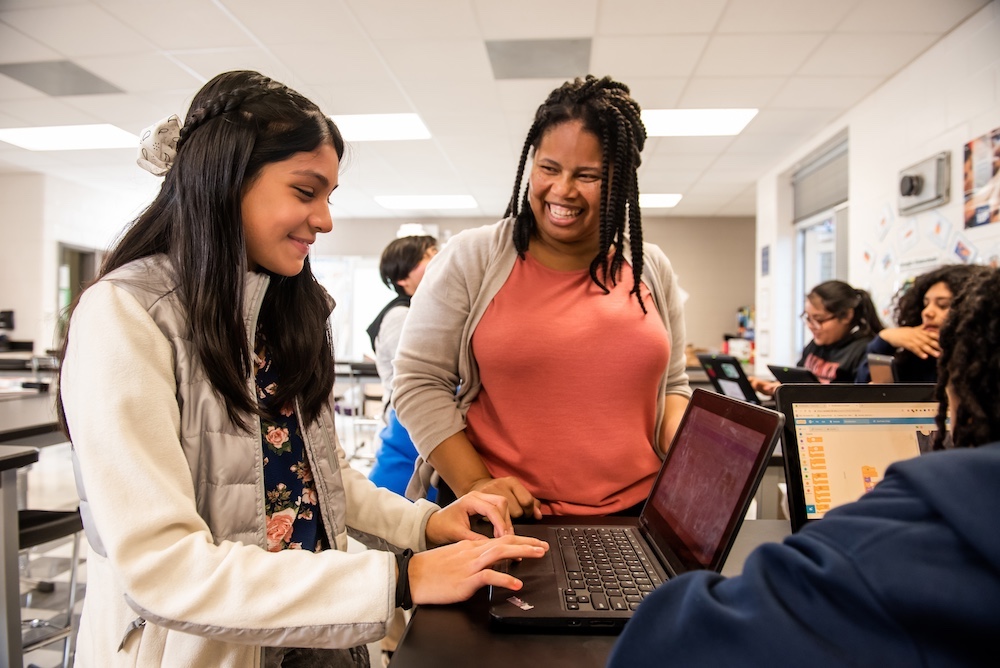 An educator helping a learner in the classroom