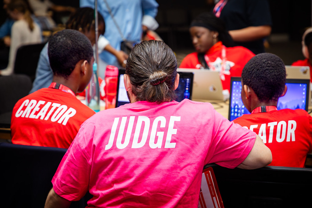 2 young creators speaking to a judge at Coolest Projects UK