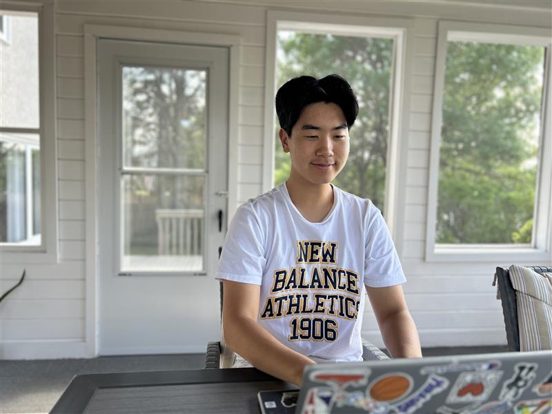 Tony working on a programming project using a laptop.