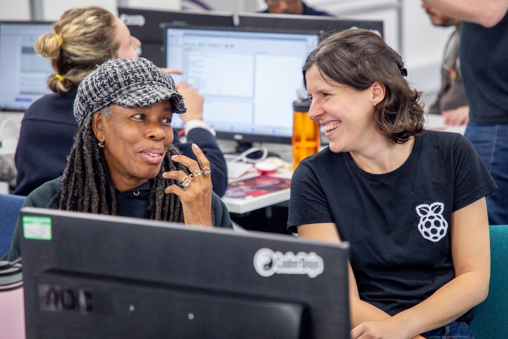 Two educators are chatting at a workshop.