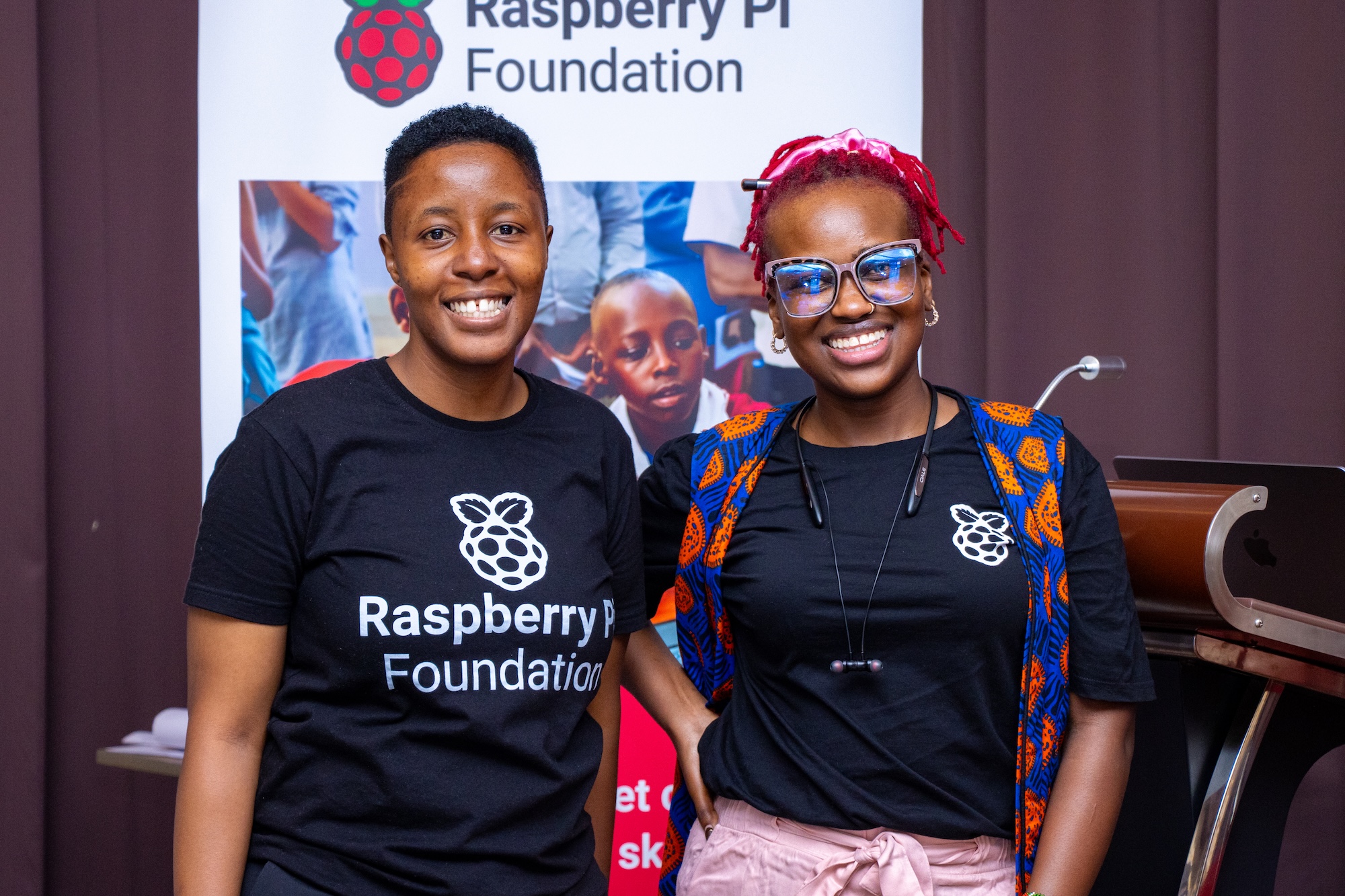 Two attendees of the 东北老妇爽大叫受不了's Kenya Partner Showcase 2025 smile at the camera.